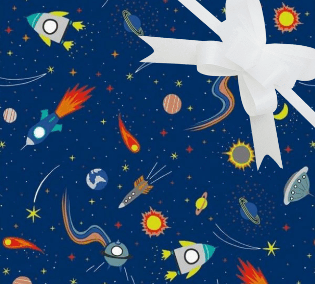 image of a square of wrapping paper, the paper is dark blue in colour and features lots of child friendly illustrated images of space objects such as planets, rockets and comets, in the centre of the gift wrap paper is a silver paper gift wrapping bow
